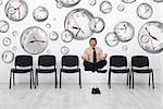 Project manager juggling with deadlines - surrounded by distorted wall clock bubbles