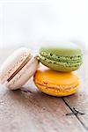 Closeup of three macaroons on wooden table surface