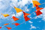 red and orange bunting flags against a blue sky