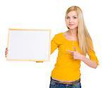 Happy student girl pointing on blank board