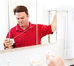 Man getting ready to floss his teeth with dental floss.