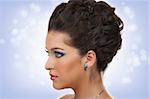 Young woman with beautiful hairstyle, make up and sapphire jewelry