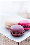 Closeup of three different flavoured macaroons on wooden table