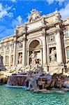 Vertical image of famous Trevi Fountain under blue sky in Rome, Italy.