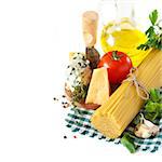 Cheese, tomatoes, basil and bundle of spaghetti on a white background.