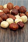 Heap of Perfect Hazelnuts closeup on Dark Wood background