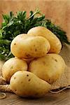 fresh organic potatoes on a wooden table