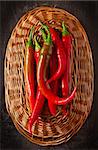 Red chili on a wicker basket close up.