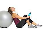 Tired fitness young woman relaxing after workout on fitness ball