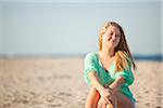 Portrait of Young Woman Sitting on Beach, Palm Beach Gardens, Palm Beach County, Florida, USA