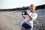 Young Woman Taking Pictures at Beach with Camera, Palm Beach Gardens, Palm Beach, Florida, USA