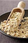 Close-up of Bowl of Oat Flakes with Scoop, Studio Shot