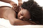 Young black woman in a salon receiving a back massage