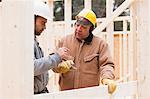 Construction foreman reviewing home under construction