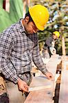 Carpenter preparing bevel cut for a rafter