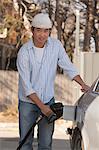 Chinese man refuelling his car at the gas station