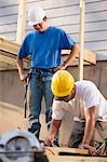 Carpenter measuring deck joist for cutting