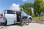 Man with muscular dystrophy and diabetes getting in an accessible van