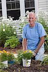 Senior man preparing to plant flowers in his garden