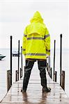 Public works engineer on dock carrying water sample packet from lake, Portland, Maine, USA