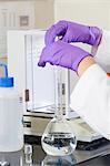 Laboratory scientist adding a precision amount of indigo into water sample flask