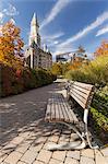 Bench in a park with buildings in the background, Rose Kennedy Greenway, Custom House, Grain Exchange Building, Boston, Massachusetts, USA