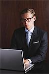 Businessman with glasses using laptop