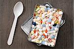 Overhead View of Tablets in Metal Box with Spoon, Studio Shot