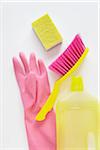 still life of cleaning products including sponge, bottle of cleaner, rubber glove, and hand broom