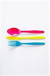 still life of colored plastic cutlery