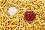 still life of french fries with ketchup and mayonnaise