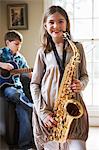 Smiling girl playing saxophone