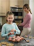 Mother and daughter baking together