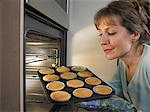 Woman baking cupcakes in kitchen