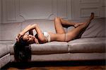 Woman in lingerie laying on sofa