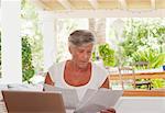 Older woman paying bills on laptop