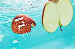 Sliced apple splashing into water