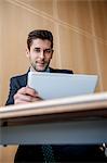 Businessman using tablet computer at desk