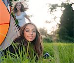 Teenage girl laying in tent at campsite