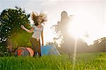 Teenage girls dancing in field