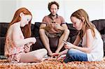 Girls playing cards on living room floor