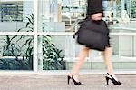 Businesswoman walking on city street