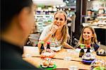 Mother and daughter eating at deli