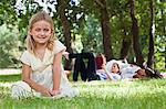 Girl sitting in grass at park