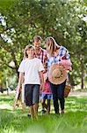 Family with picnic basket in park