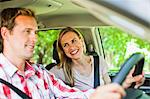 Smiling couple riding in car