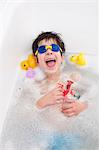 Boy in snorkel mask laughing in bath