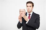 Businessman holding mask