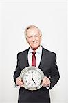 Businessman holding clock