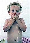 Toddler boy washing in bath